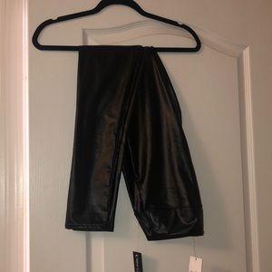 faux leather leggings made of 92% polyester and 8% spandex, size medium.